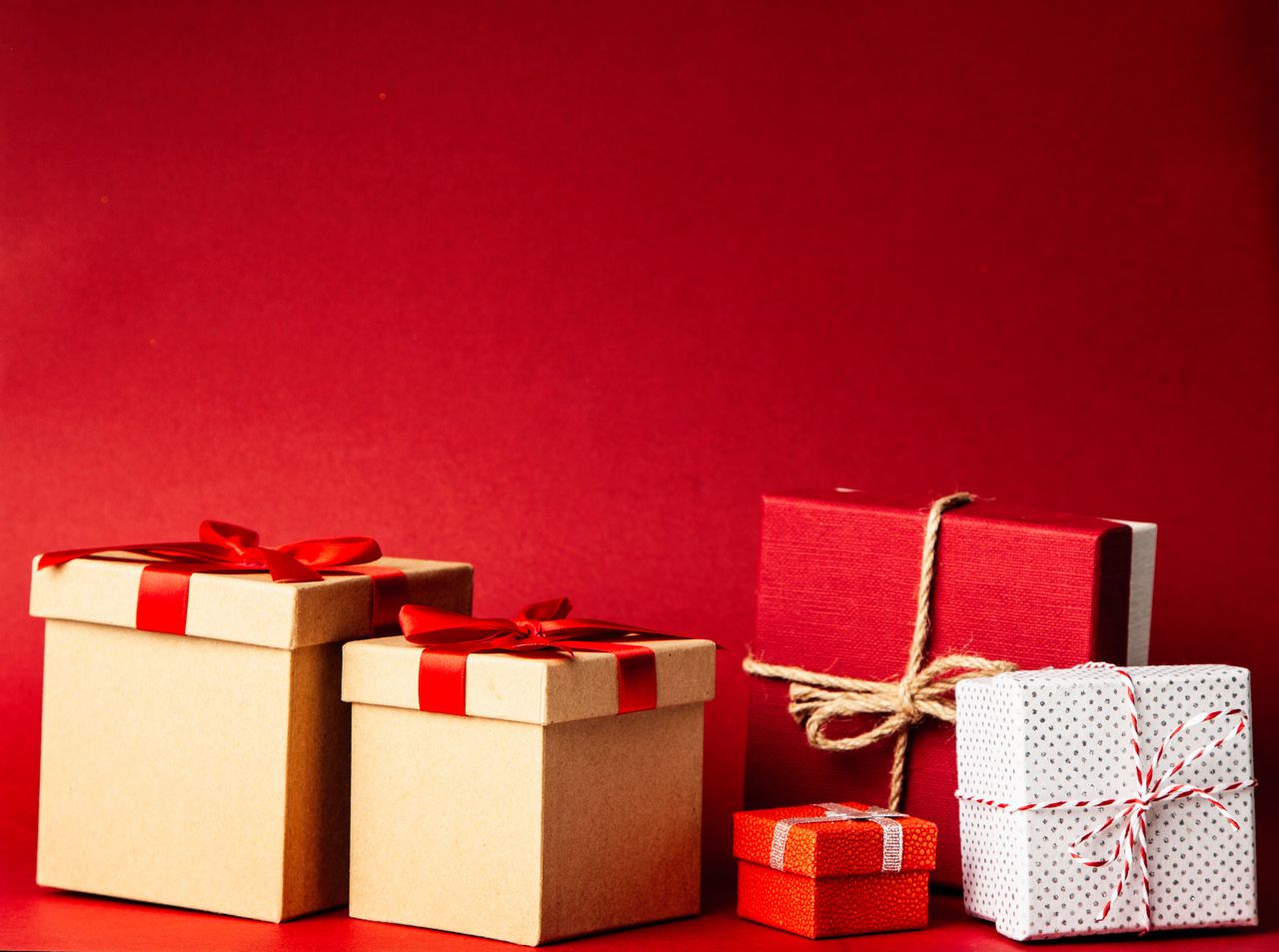 Crafting Captivating Headlines: Your awesome post title goes here A collection of colorful gift boxes with ribbons on a rich red background, perfect for holiday themes.